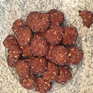 Glass plate with chocolate cookies on a stone surface