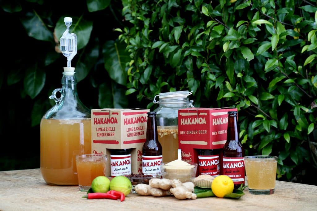 Hakanua ginger beer products on a table with greenery in the background