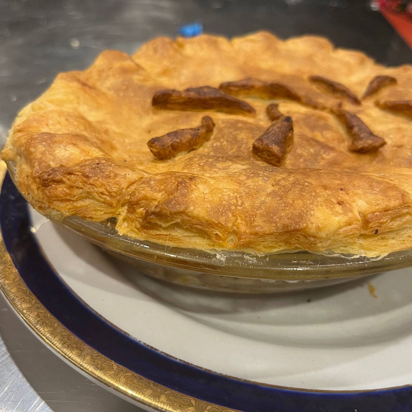 Pastry dish with a baked pie on a white plate with blue rim