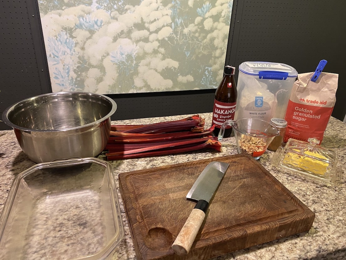 Ingredients and kitchen tools on a countertop with a blurred background Rhubarb & Ginger Crumble